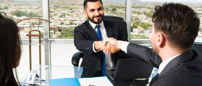 Businessman shaking hands with a company executive after making a lucrative business deal. Smiling sales representative making a successful sale